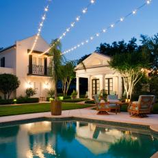 Traditional Pool With Poolhouse and Twinkly Outdoor Lighting