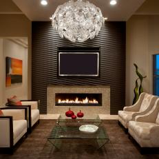 Formal Living Room with Modern Chandelier and Wood-clad Fireplace Surround