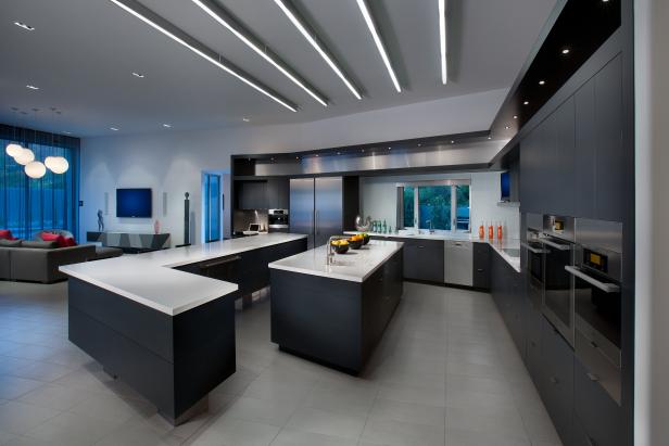 Large modern kitchen with family room in gray, black and white. 