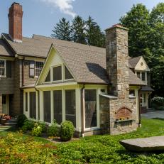 Colonial Home Boasts Screened Porch With Stone Fireplace