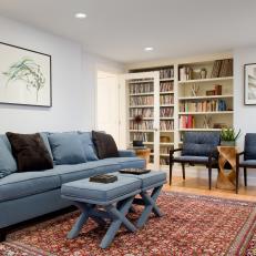 Sitting Area and Library with Blue Sofa, Upholstered Ottoman and Oriental-style Rug