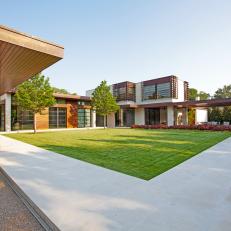 Modern Home with Grass Courtyard in the Center of Several Buildings
