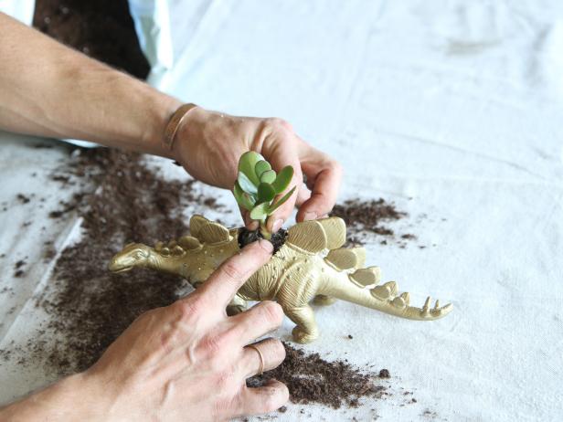 Insert plants and add soil to the animal figurine.