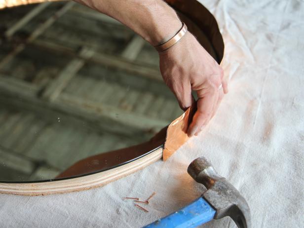 Attach copper flashing to frame by nailing it into the frame with copper pin nails.