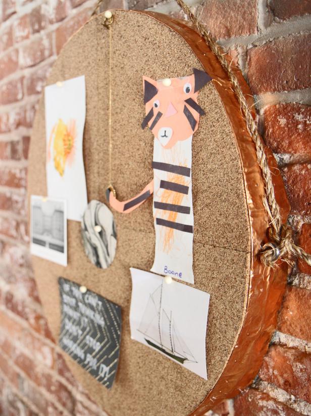 Hang memos and your kids' art on a round bulletin and mirror that has a copper edge accent.
