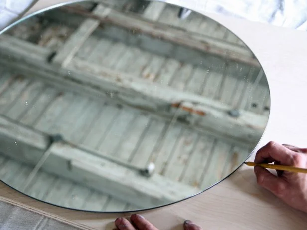 Trace the round mirror shape on a piece of plywood.