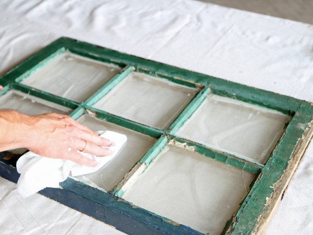 Wipe away dust and debris from window panes with a dry cloth.