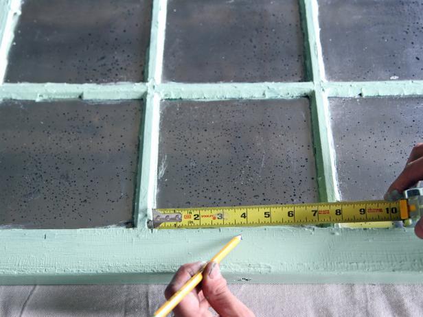 Measure for the center of each window frame at the bottom, and make a mark with a pencil.