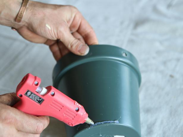 Apply hot glue to the bottom edge of the plastic pot.