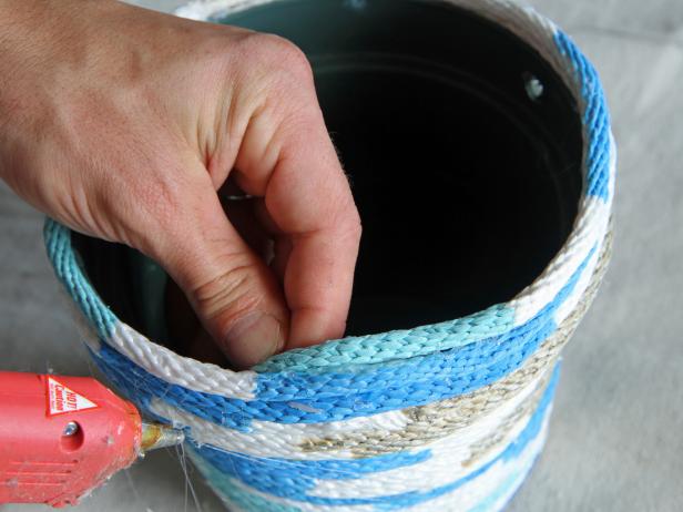 Secure the end of the rope to the inside lip of the pot using hot glue.