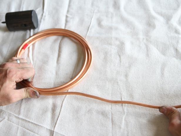 Uncoil the 1/4” soft copper refrigeration pipe.