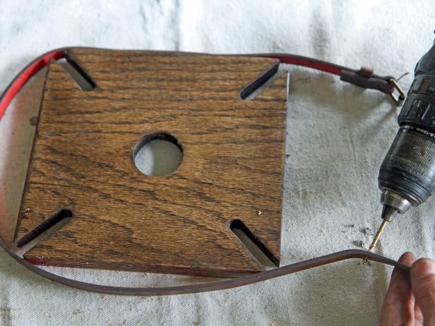 Place the buckle of the 1/2” leather belt in the approximate center of one side of the wood block and on the adjacent side, secure the belt to the wood using 1 ½” brass screws.