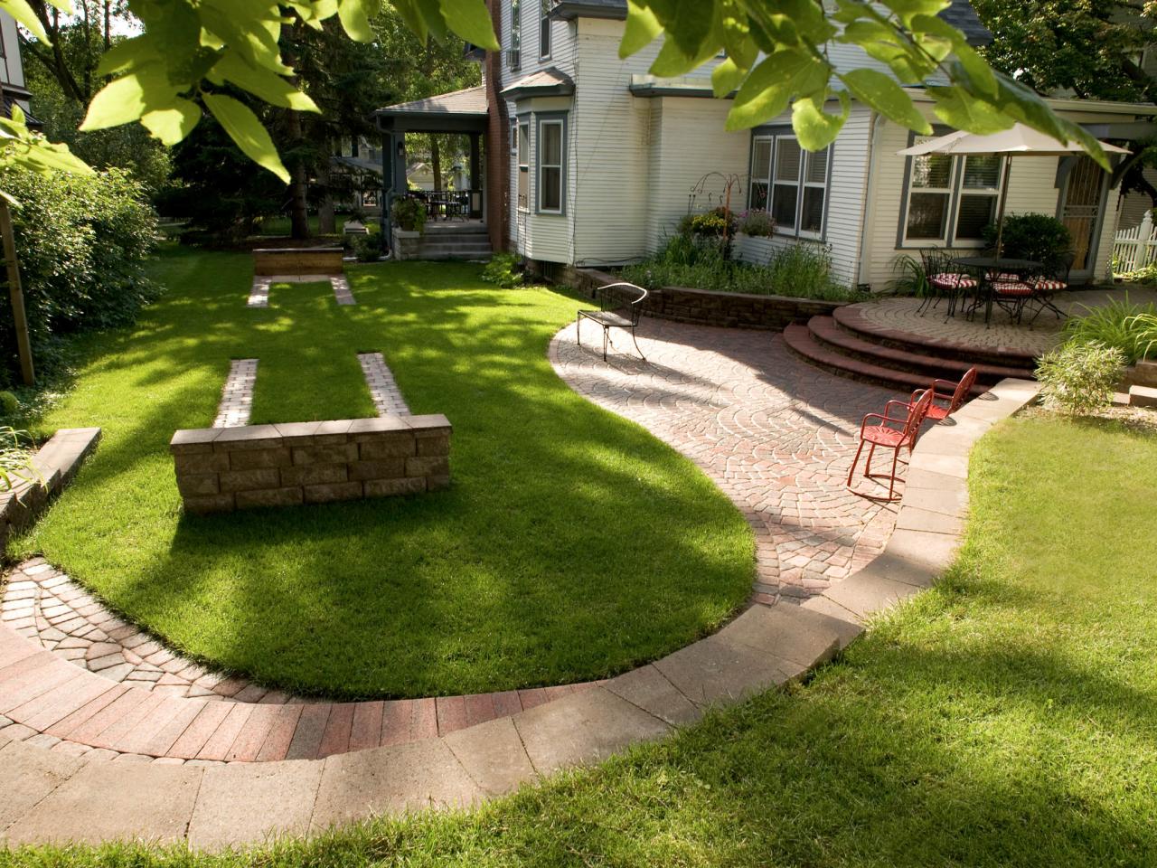 Shaded Backyard with Horseshoe Pit, Pavers and Patio | HGTV