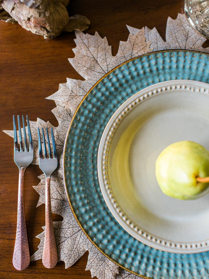 Turquoise and White Table Setting With Leaf Placemat and Pear