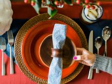 Fall Table Setting With Wood Charger, Red Plate and Patterned Napkin