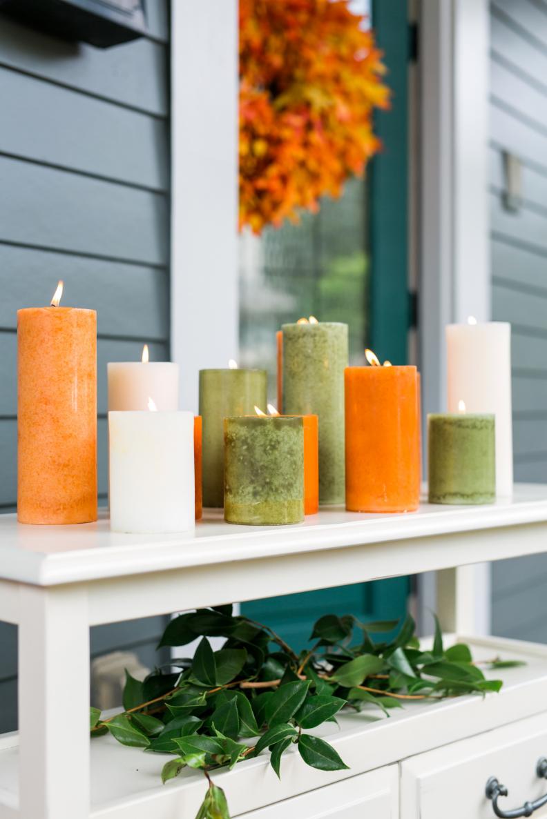 Looking for a quick and easy way to add a touch of autumn to your front porch or entryway? Add a grouping of colored pillar candles along a console or entry table, varying in heights and hues.
