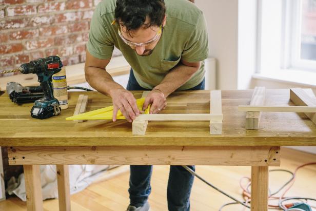 Attach brace to table legs using a speed square and nail gun.