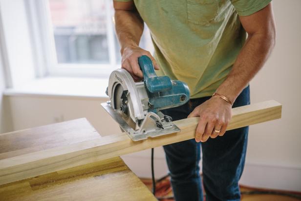 Cut four balusters with a circular saw to make the table legs.