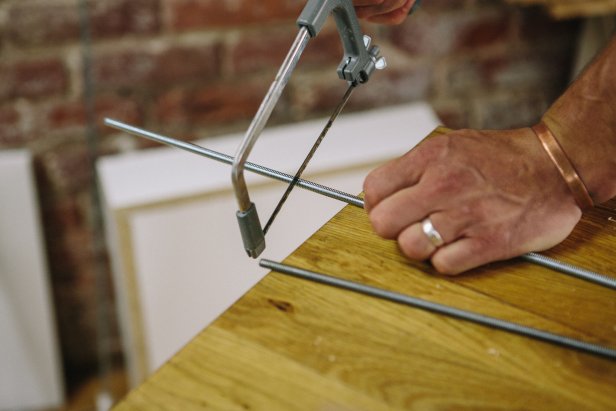 Cut threaded rods using a hack saw.