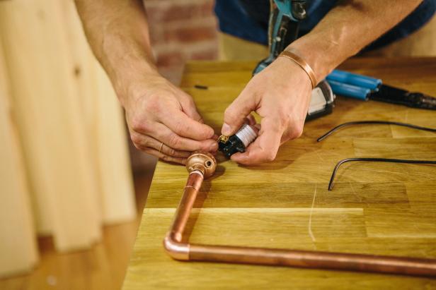 Attach lamp parts to copper piping to make an industrial-style sconce.