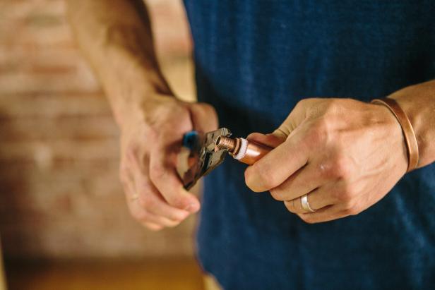 Attach adapter to copper piping to make an industrial-style sconce.