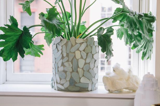 a stone tile planter sitting on a windowsill