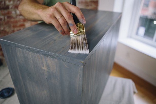 Apply polyurethane to cabinet.