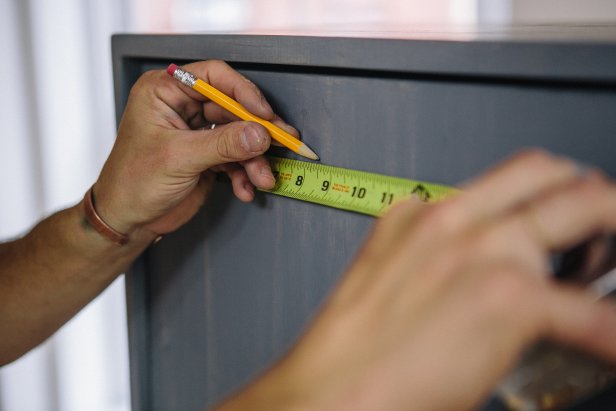 Measure the top center of the cabinet to mark knob location.