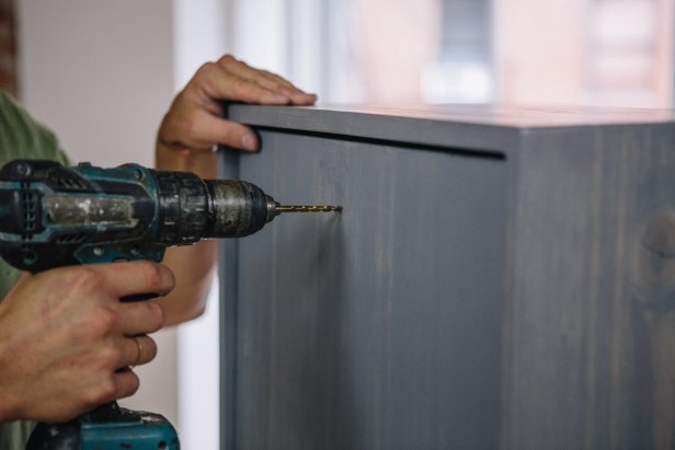 Drill hole in cabinet door before attaching knob.