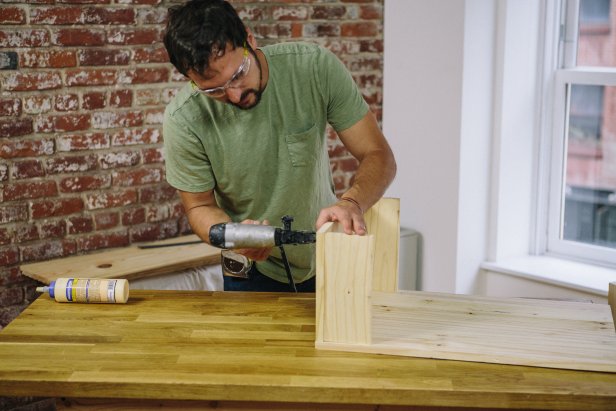 Attach tray supports to cabinet door.