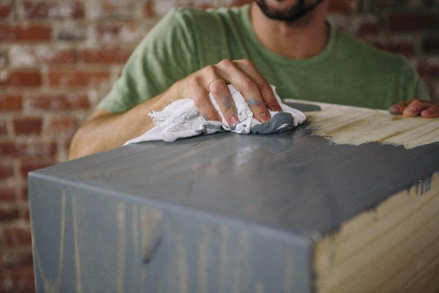 Wipe excess stain from cabinet to allow wood grain to show through.