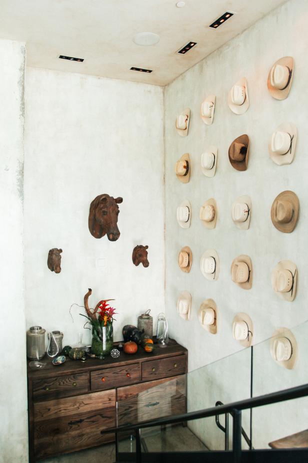 Stairway Landing With Rustic Wood Dresser and Cowboy Hat Display