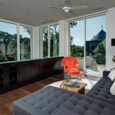 Modern Lounge Area Boasts Bold Orange Chair