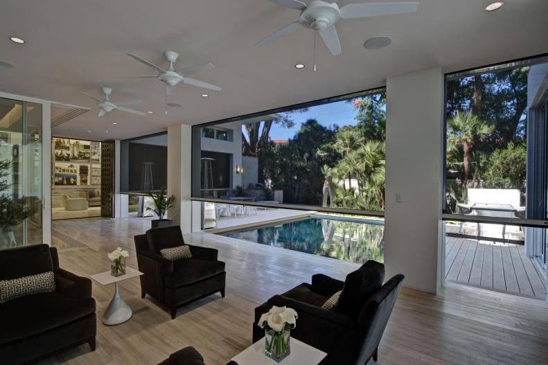 Contemporary Patio With Charcoal Gray Armchairs and Ceiling Fans