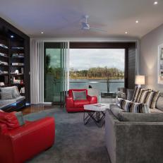 Family Room Features Gray Velvet Sectional & Red Leather Chairs