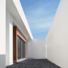 White Modern Courtyard With Black Stones