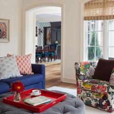 Gray Ottoman and Multicolored Floral Armchair