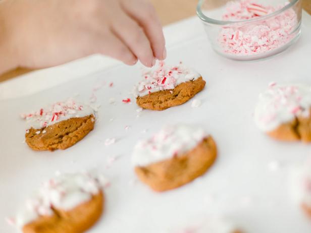 While the chocolate is still warm, sprinkle crushed peppermint onto the top of each cookie, then place in the refrigerator to cool for about 15 minutes TIP -If you're looking for a fun way to present these delicious cookies to guests, try stacking them. Place a square of wax paper between each cookie, then tie off with a festive bakers twine.