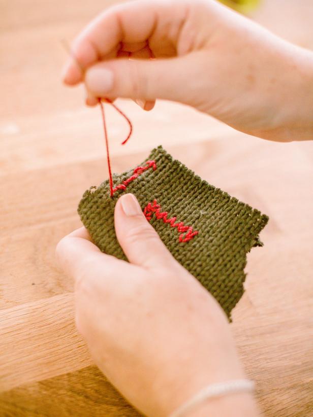 Once the interfacing is attached, place the two sides of the mitten together, then, using a blanket stitch, join together to create a pocket for treats, leaving the top of the mitten open for inserting treats.