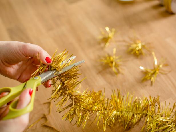 Using scissors and/or wire cutters, snip little sections of tinsel and set aside. If you're using tinsel wire, use wire cutters to snip into small pieces, then needle nose pliers to bend each section into a ball shape, so that it stands up well inside the ornament.