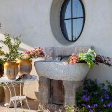 Outdoor Space with Stone Garden Sink and Round Window