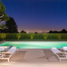 Home with a Pool, Lawn and Shrubs overlooking a City 