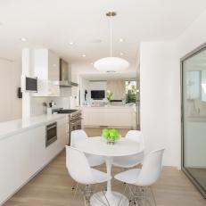 Modern, White, Eat-in Kitchen with Expansive Counter Space and White Table and Chairs