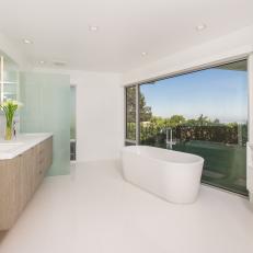 Modern White Bathroom with Floating Vanity, Large Picture Window and Soaking Tub