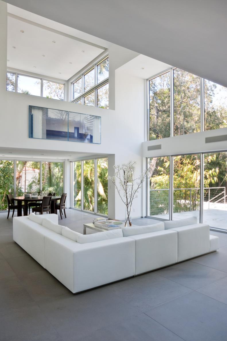 Two-Story Modern White Living Space With White Sectional