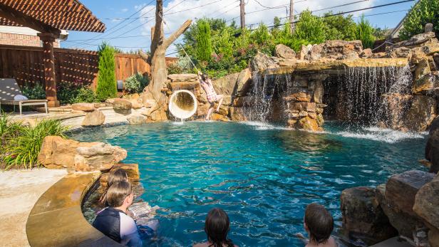 Tropical Backyard Pool With Rope Swing and Waterfall | HGTV