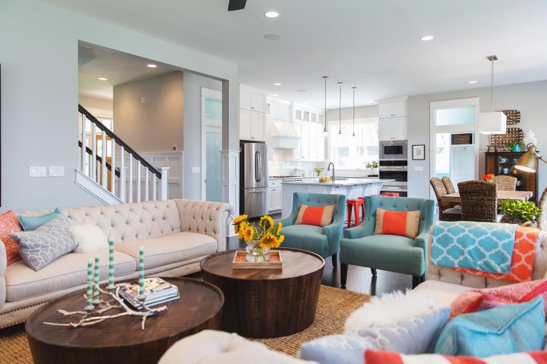 Open Concept Living Room With Turquoise Chairs and Wood Coffee Tables