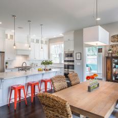 Eat-In Kitchen With White Cabinetry, Kitchen Island, Red Barstools & Butcher Block Table