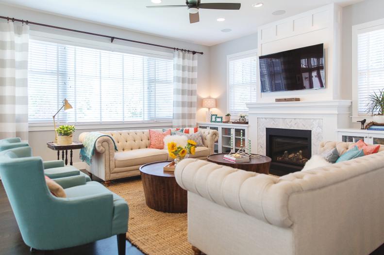 Transitional Living Room With Fireplace, Blue Chairs & Cream Sofas