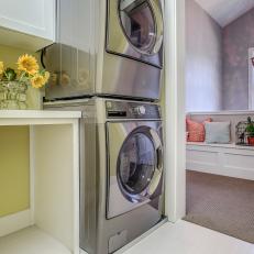 Laundry Room With Green Walls, White Cabinets and Storage Bench